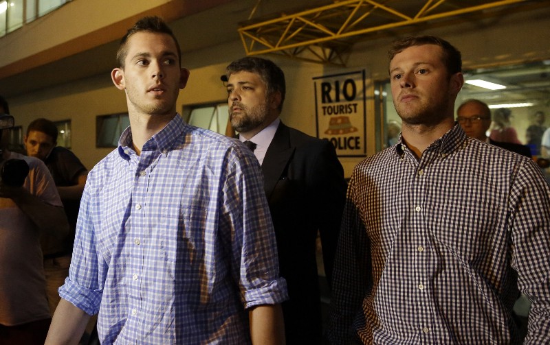 American Olympic swimmers Gunnar Bentz, left, and Jack Conger leave a police station in Rio de Janeiro, Brazil, Thursday, Aug. 18, 2016. The two were taken off their flight from Brazil to the U.S. on Wednesday by local authorities amid an investigation into a reported robbery targeting Ryan Lochte and his teammates. CREDIT: AP PHOTO/LEO CORREA