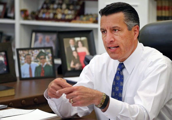 Nevada Gov. Brian Sandoval (R) came out against a background check initiative that gun control advocates are supporting on the ballot, saying it would unnecessarily restrict the rights of law-abiding Nevadans. CREDIT: AP Photo/Cathleen Allison