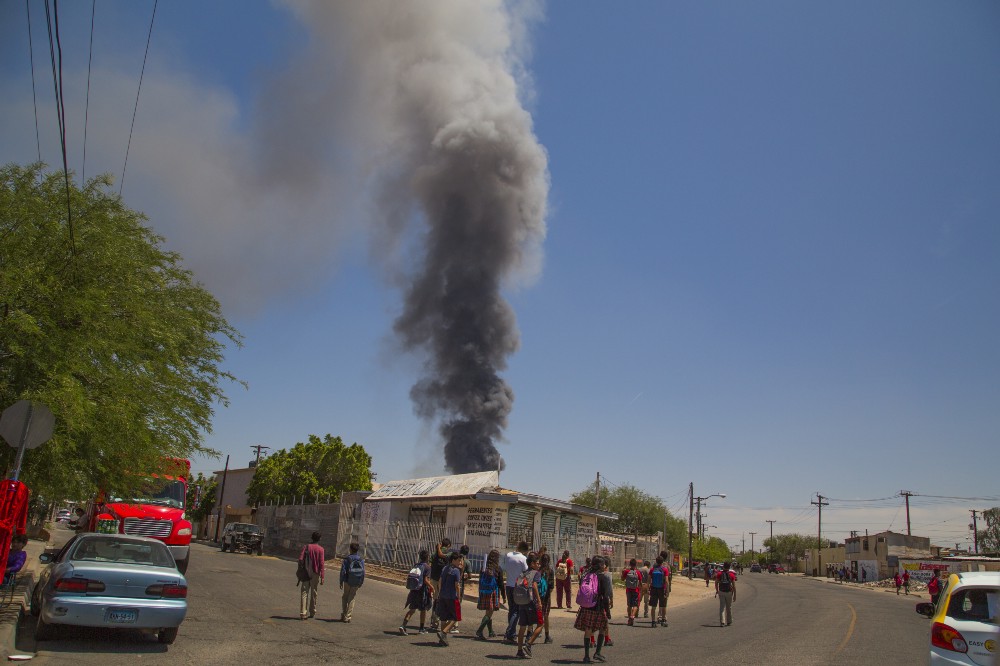 A plume of smoke rises near a school in Mexicali, Baja California. Billowing smoke is common in this sprawling city. CREDIT: ALEJANDRO DÁVILA FRAGOSO, THINKPROGRESS