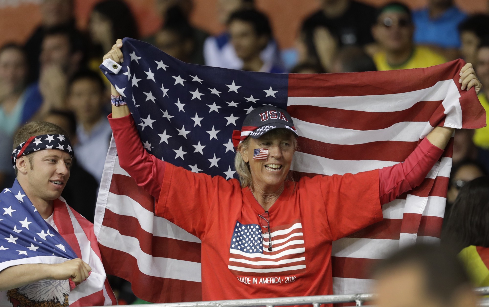 A fan bearing a United States flag is seen during the second half of a women’s basketball game between the United States and Spain at the 2016 Summer Olympics CREDIT: AP PHOTO/CARLOS OSORIO