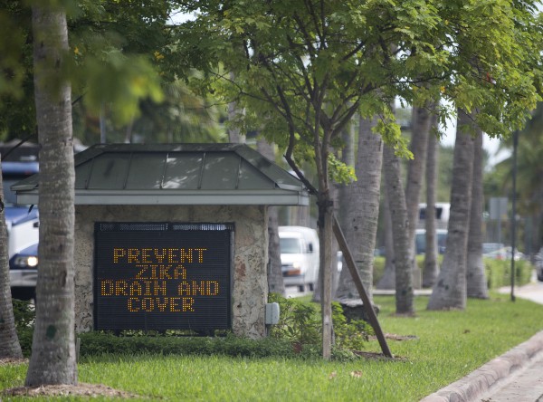 A sign at the Key Biscayne, Florida city line reminds residents to drain or cover standing water to prevent mosquitos from reproducing. The Florida health department tested more than 3,536 people statewide for the Zika virus. CREDIT: AP PHOTO/WILFREDO LEE