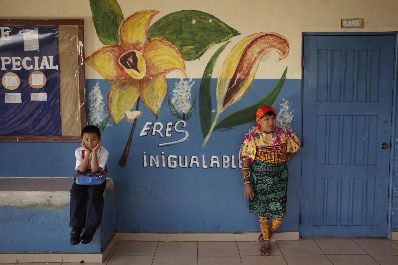A school boy and his mother, dressed in traditional Kuna indigenous clothing, wait for start of the first day of school in Panama City CREDIT: AP PHOTO/ARNULFO FRANCO