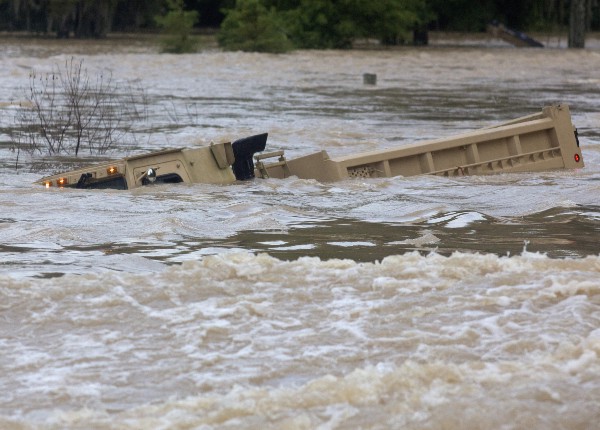 A Louisiana Army National Guard dump truck is submerged in flood waters. CREDIT: AP Photo/Max Becherer