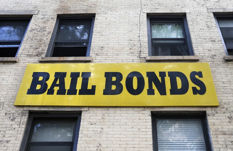 In this photo taken Tuesday, July 7, 2015, a bail bonds sign hangs on the side of a bail bonds business near Brooklyn’s courthouse complex and jail in New York. CREDIT: AP/KATHY WILLENS