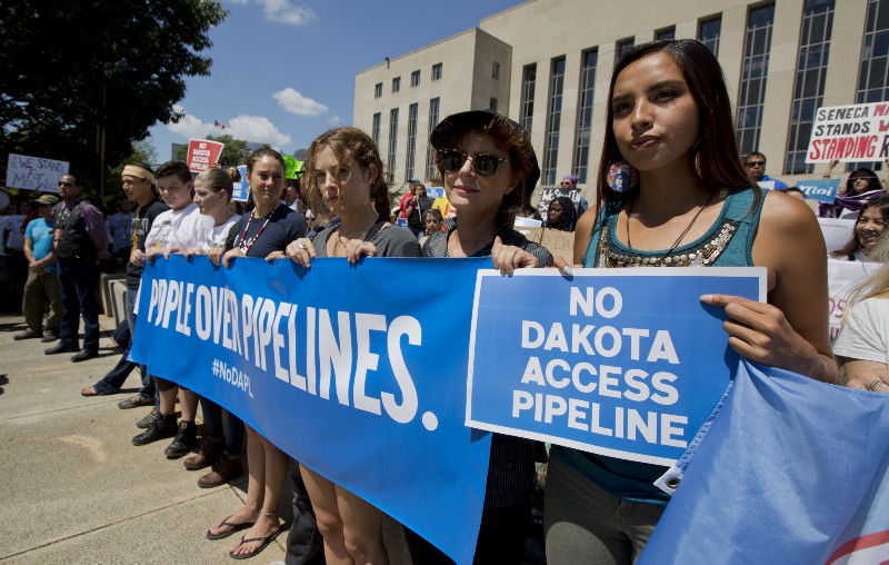 Actresses Shailene Woodley, fourth from right, and Susan Sarandon, second from right, and Standing Rock Sioux Tribe member Bobbi Jean Three Lakes, right, participate in a rally outside the US District Court in Washington. CREDIT: AP/MANUEL BALCE CENETA