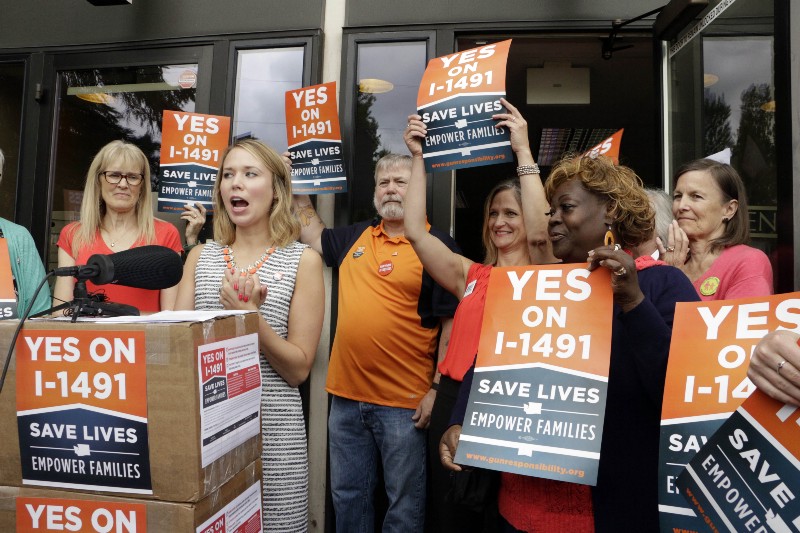 Stephanie Ervin, campaign manager for Yes on I-1491, speaks to the media about the turn in of more than 330,000 signatures in support of a ballot measure on gun access, on Thursday, July 7, 2016, in Olympia, Wash. CREDIT: AP Photo/Rachel La Corte
