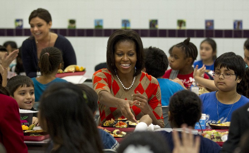 First lady Michelle Obama has lunch with children at an elementary school in Alexandria, VA, in 2012. CREDIT: AP Photo/Pablo Martinez Monsivais