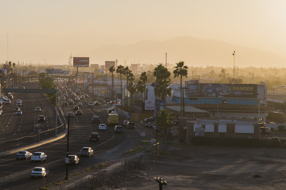 The sun sets as dust and smoke make the towering mountains west of Mexicali, Baja California, barely visible. CREDIT: ALEJANDRO DÁVILA FRAGOSO, THINKPROGRESS