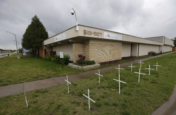 Crosses placed by anti-abortion protesters stand in the lawn outside the South Wind Women’s Center in Wichita, Kansas. CREDIT: AP PHOTO