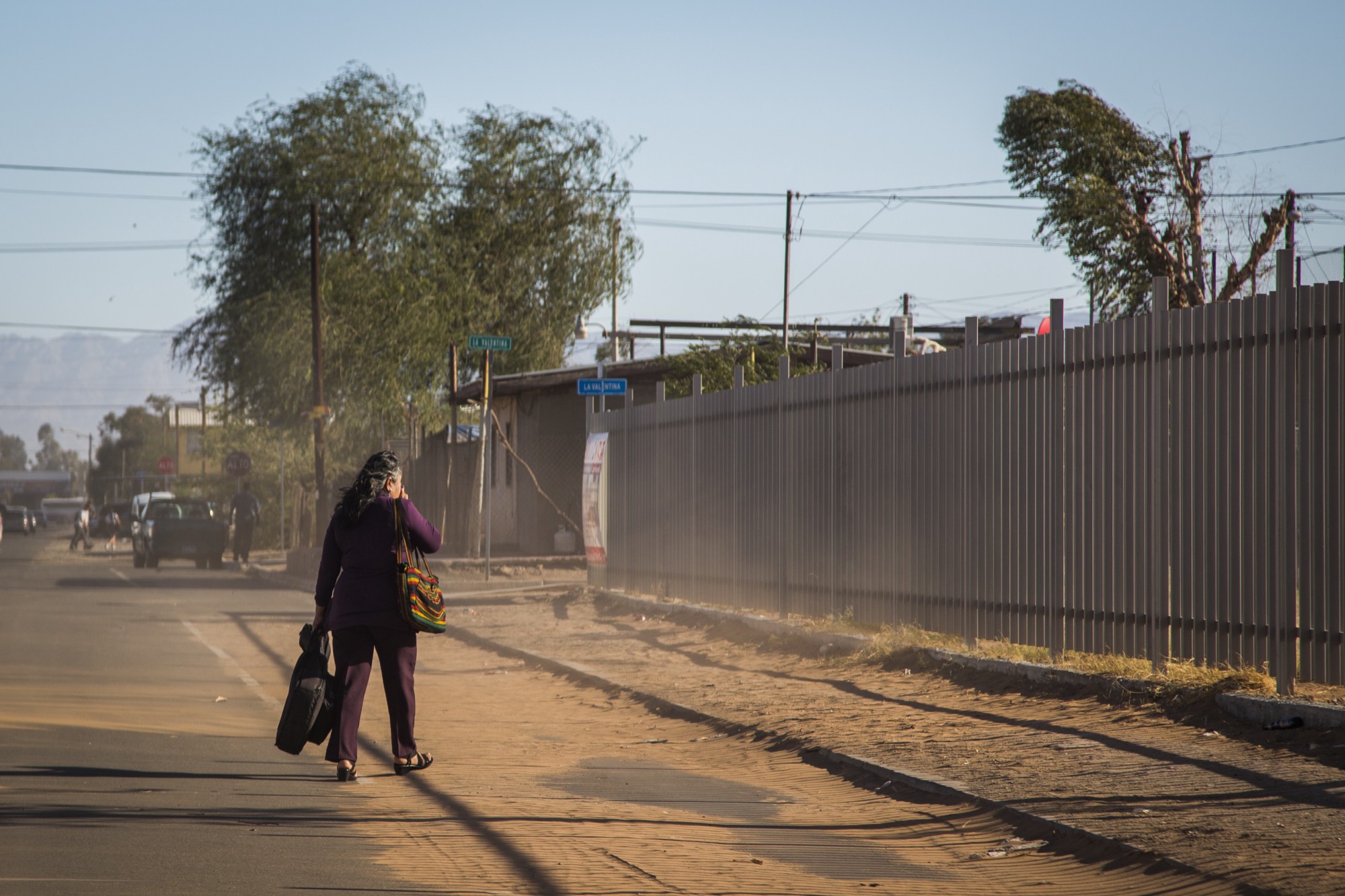 Martha Quintero walks home during a wind event in the desert city of Mexicali, Baja California. CREDIT: ALEJANDRO DÁVILA FRAGOSO, THINKPROGRESS
