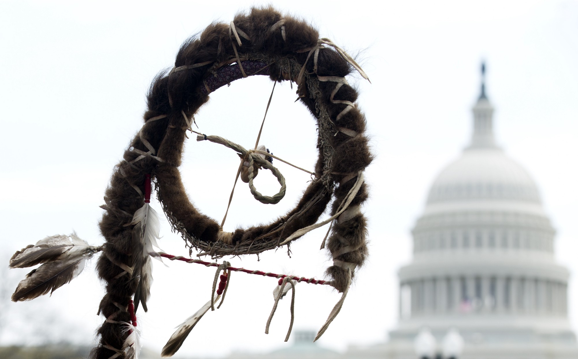 A Native American prayer stick is held near the capital during a Keystone XL protest in 2014. CREDIT: AP Photos/Manuel Balce Cenata