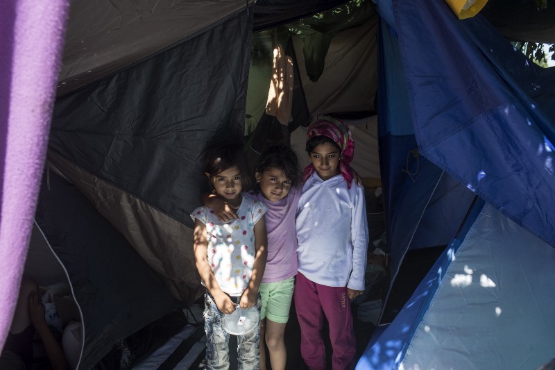 Children stand in a tent inside a migrant camp at Serbia’s border with Hungary, in Horgos, Serbia, Monday, July 11, 2016. CREDIT: AP Photo/Marko Drobnjakovic