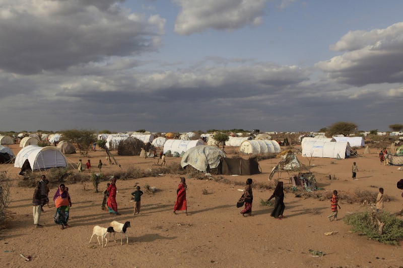Somali refugees walk through an area housing new arrivals, on the outskirts of Hagadera Camp outside Dadaab, Kenya, Saturday July 9, 2011. CREDIT: AP Photo/Rebecca Blackwell, File