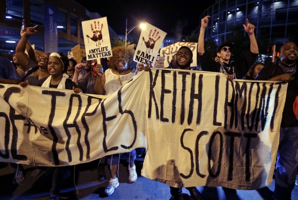 Demonstrators in Charlotte on Friday evening. (Credit: AP PHOTO/CHUCK BURTON)