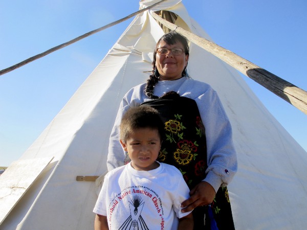 A Lakota Sioux and her 5-year-old son pose for a photo at a protest camp erected to halt the construction of the Dakota Access Pipeline. CREDIT: AP Photo/James MacPherson