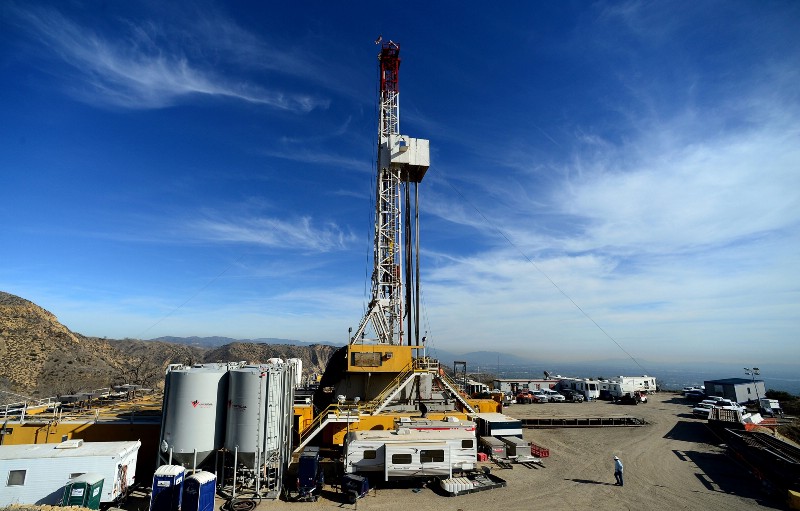 In this Dec. 9, 2015 photo, crews work on stopping a gas leak at a relief well at the Aliso Canyon facility above the Porter Ranch area of Los Angeles. CREDIT: DEAN MUSGROVE/LOS ANGELES DAILY NEWS VIA AP, POOL, FILE