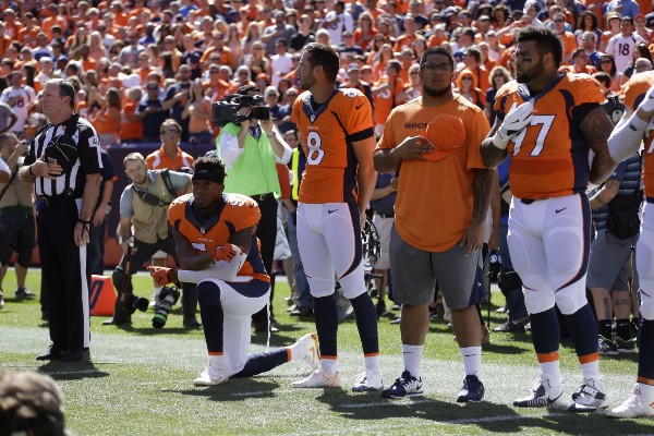 Brandon Marshall takes a knee during the National Anthem, Sept. 18, 2016, in Denver. CREDIT: AP PHOTO/JACK DEMPSEY