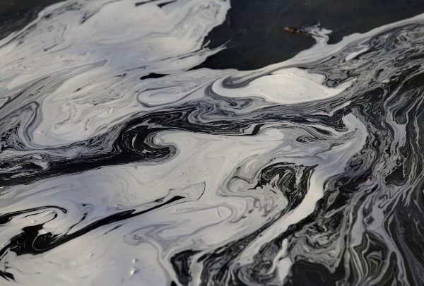 Coal ash swirls on the surface of the Dan River in 2014, following one of North Carolina’s biggest environmental disasters in its history. CREDIT: AP/Gerry Broome