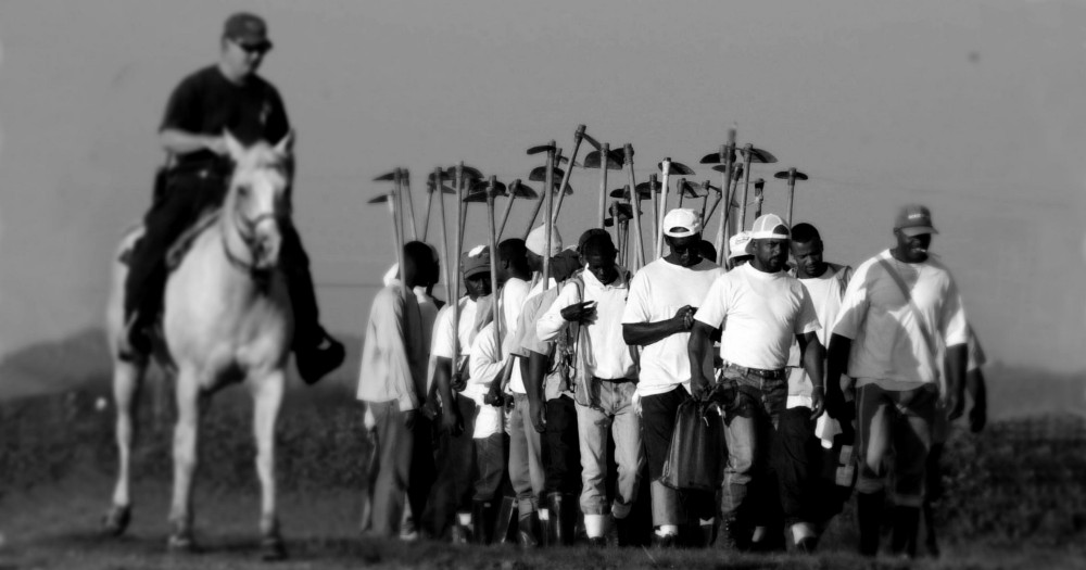Louisiana Department of Corrections Sgt. Boo McKey watches a work crew head to the fields at the Louisiana State Penitentiary in Angola, La. CREDIT: AP Photo/Bill Haber/Dylan Petrohilos/ThinkProgress