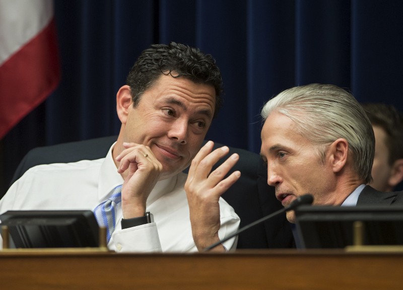 Republican committee chair Rep. Jason Chaffetz (R-UT) confers with a prominent GOP opposition researcher. CREDIT: AP PHOTO/J. SCOTT APPLEWHITE