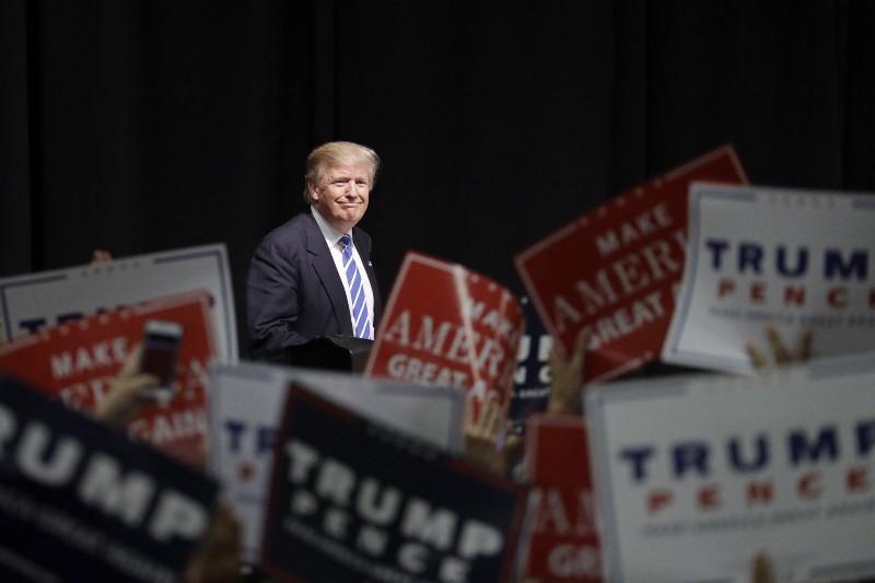 Republican presidential candidate Donald Trump takes the stage at a rally, Wednesday, Sept. 28, 2016, in Council Bluffs, Iowa. CREDIT: AP Photo/John Locher