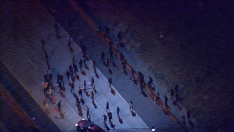 On the second night of protests, people briefly blockaded the downtown loop highway that helped gut multiple prosperous black communities many decades ago. CREDIT: WSOC/Screencap