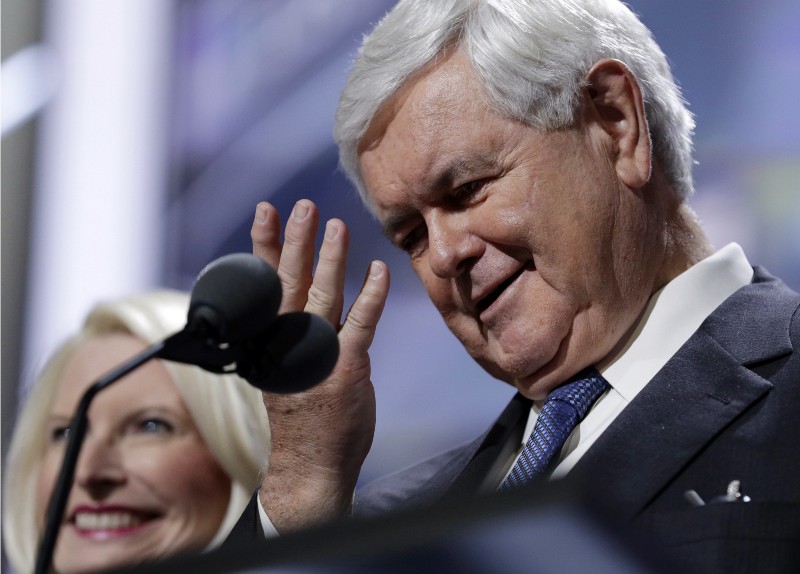 Former Speaker of the House Newt Gingrich, right, jokes around while he and his wife Callista test the speaking setup before the third day session of the Republican National Convention CREDIT: AP PHOTO/JOHN LOCHTER