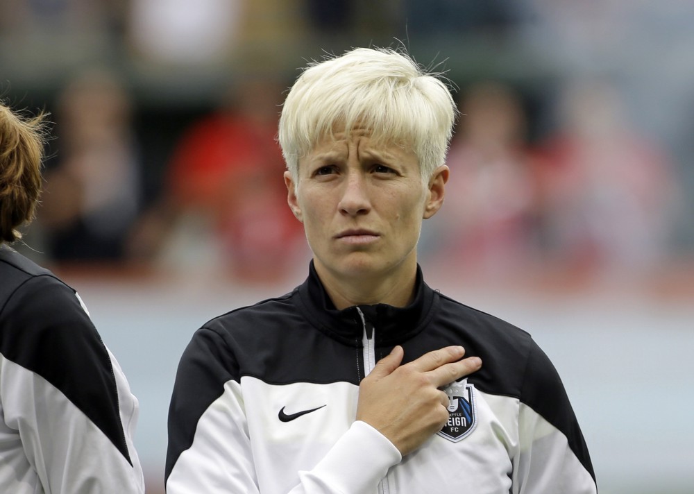 Megan Rapinoe during the national anthem before an NWSL soccer match against the Portland Thorns, July 22, 2015. CREDIT: DON RYAN, AP