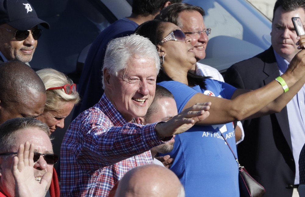 Former President Bill Clinton marches with union members in their annual Labor Day parade, Monday, Sept. 5, 2016 in Detroit. CREDIT: AP Photo/Carlos Osorio