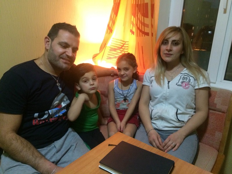 Syrian refugee Nihad Sadder, left, and his family pose for a photo in Murmansk, Russia, Jan. 28, 2016. CREDIT: AP Photo/Roman Stepanovich