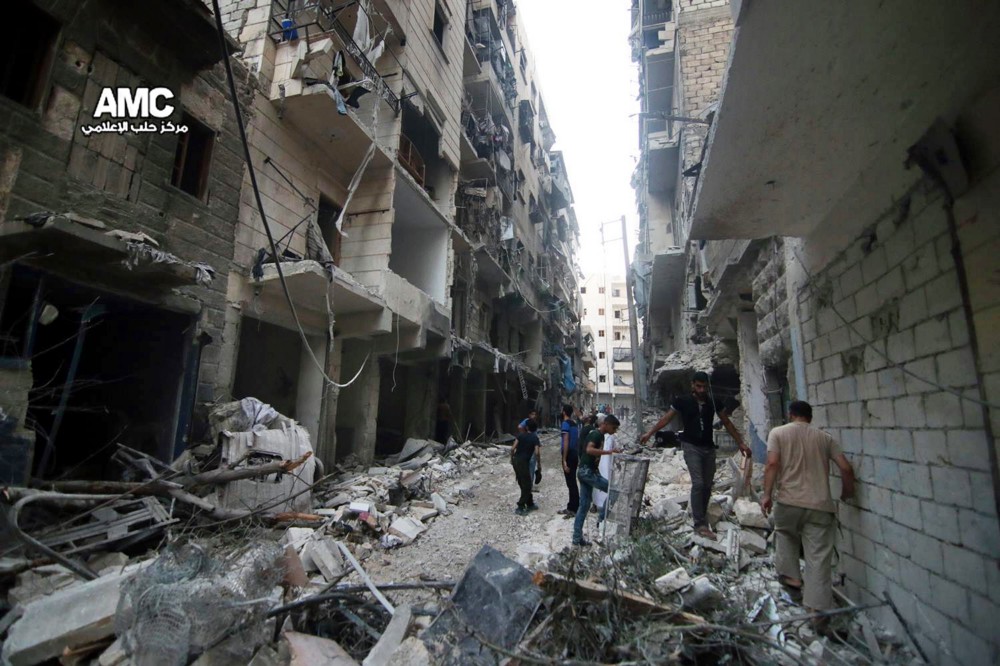 In this Friday, July. 29, 2016 photo, provided by the Syrian anti-government activist group Aleppo Media Center (AMC), Syrian citizens inspect damaged buildings after airstrikes hit Aleppo, Syria. Residents trapped in rebel-controlled Aleppo are struggling to survive the crippling encirclement of their once thriving city. Bread, medication and fuel are running short. For the tens of thousands who chose to remain, the battle for Aleppo is a pivot point in the Syrian war. CREDIT: ALEPPO MEDIA CENTER/AP