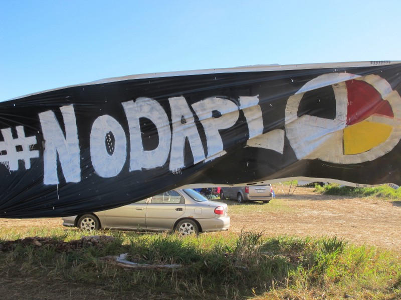 A banner protesting the Dakota Access oil pipeline is displayed at an encampment near North Dakota’s Standing Rock Sioux reservation on Friday, Sept. 9, 2016. CREDIT: AP Photo/James MacPherson