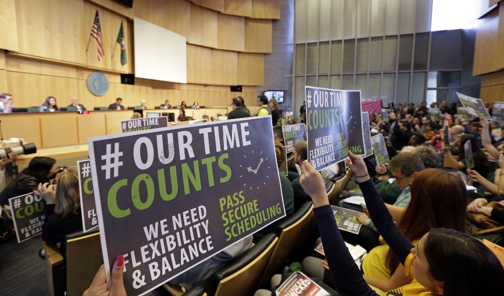 Supporters of Seattle’s new scheduling law at the city council on Monday evening. CREDIT: AP Photo/Elaine Thompson