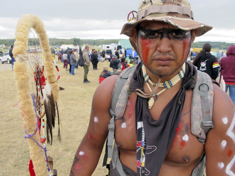Jon Don Ilone Reed, an Army veteran and member of South Dakota’s Cheyenne River Sioux Tribe, at an oil pipeline protest near the Standing Rock Sioux reservation in southern North Dakota, Aug. 25, 2016. Reed said he fought in Iraq and is now fighting “fighting for our children and our water.” CREDIT: AP/JAMES MACPHERSON