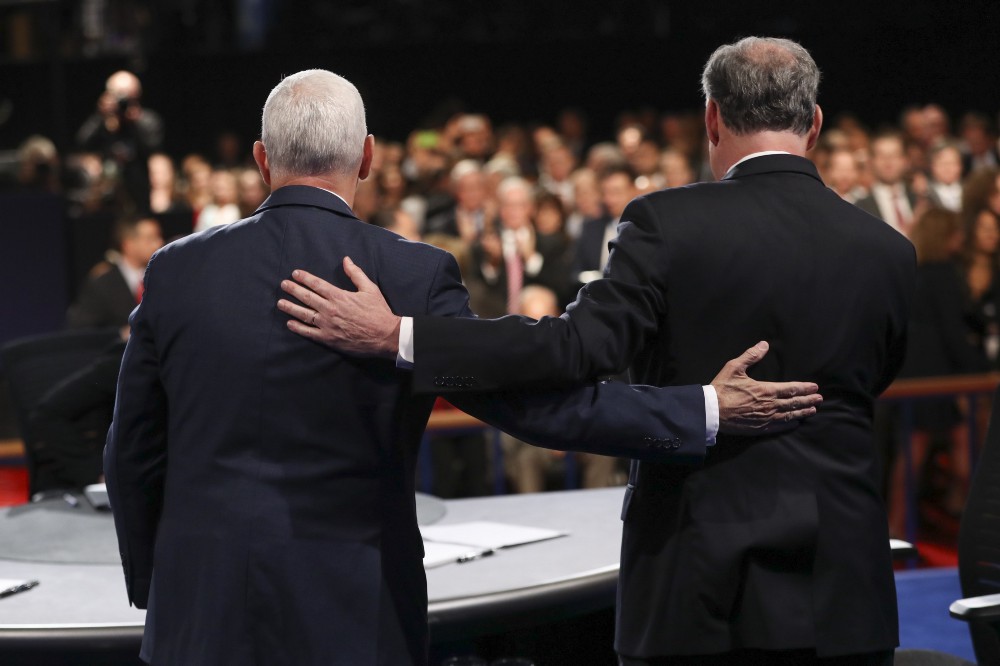 Mike Pence and Tim Kaine on the vice presidential debate stage. CREDIT: Joe Raedle/Pool via AP Photos