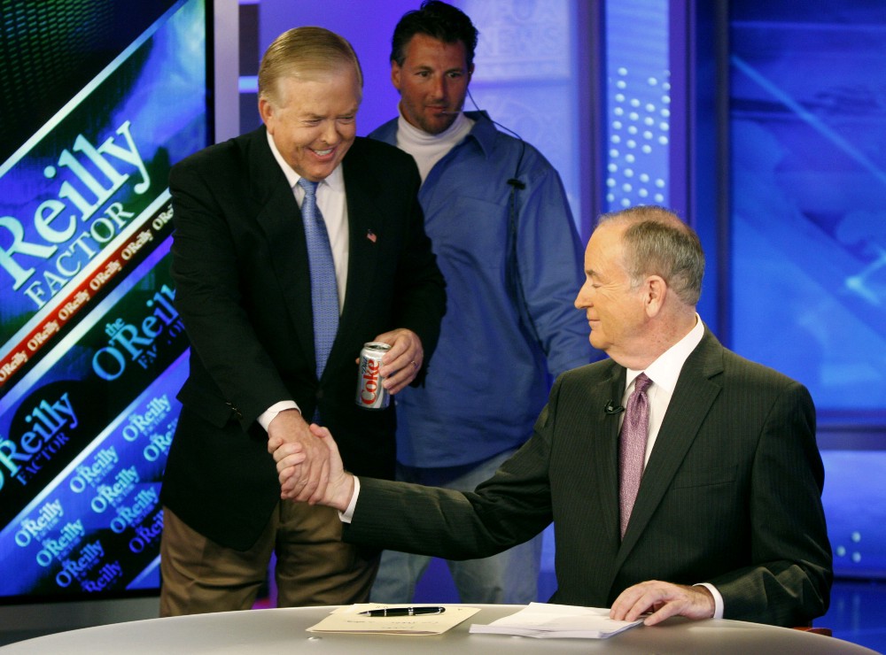 Longtime CNN commentator Lou Dobbs, left, who resigned from the cable network last week after 29 years, greets Bill O’Reilly before taping a segment for Fox News channel’s “The O’Reilly Factor,” in New York, Monday, Nov. 16, 2009 CREDIT: AP Photo/Kathy Willens