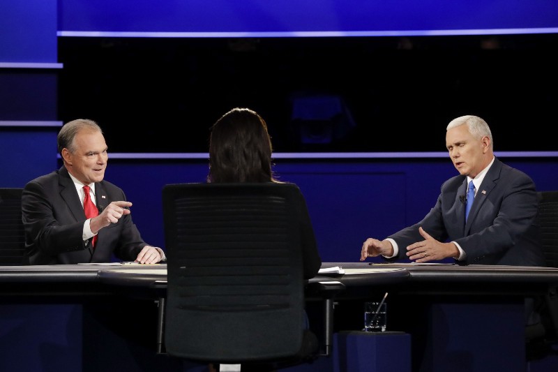 Republican vice-presidential nominee Gov. Mike Pence, right, and Democratic vice-presidential nominee Sen. Tim Kaine discuss a question during the vice-presidential debate at Longwood University in Farmville, Virginia. CREDIT: AP Photo/David Goldman