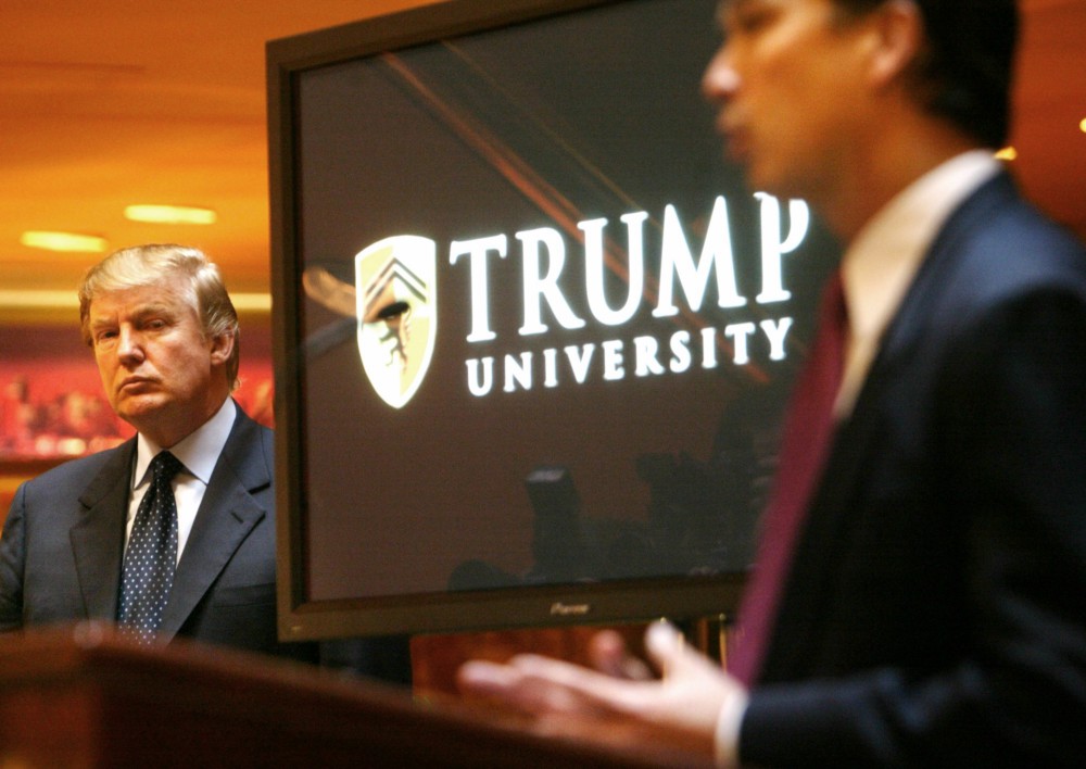 In this May 23, 2005 file photo, real estate mogul and Reality TV star Donald Trump, left, listens as Michael Sexton introduces him at a news conference in New York where he announced the establishment of Trump University CREDIT: AP Photo/Bebeto Matthews, File