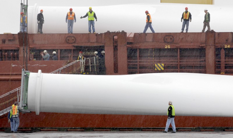 Workers unload a wind blade at the Port of Cleveland, Ohio. CREDIT: AP/Amy Sancetta