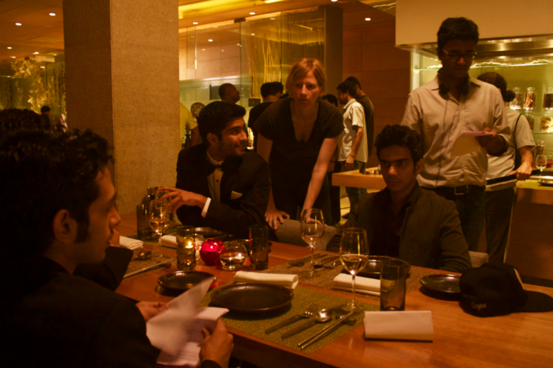 A production shot featuring director Sudhanshu Saria working with the full four-person cast. CREDIT: Loev