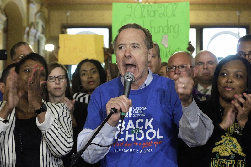 Chicago Public Schools CEO Forrest Claypool, center, speaks to school leaders, students, parents and community members from around the state during a rally for fair education funding. CREDIT: AP/Seth Perlman