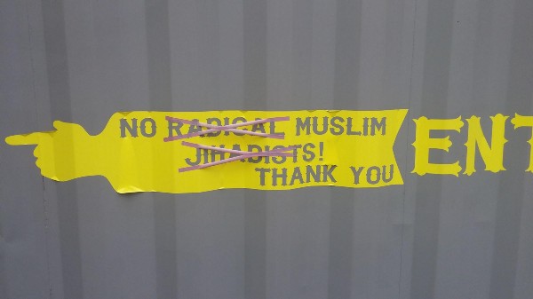 A t-shirt reading “Back from the grave to defend constitutional terrorists,” and a sign at the Pennsylvania gun store. CREDIT: Altra Firearms’ Facebook