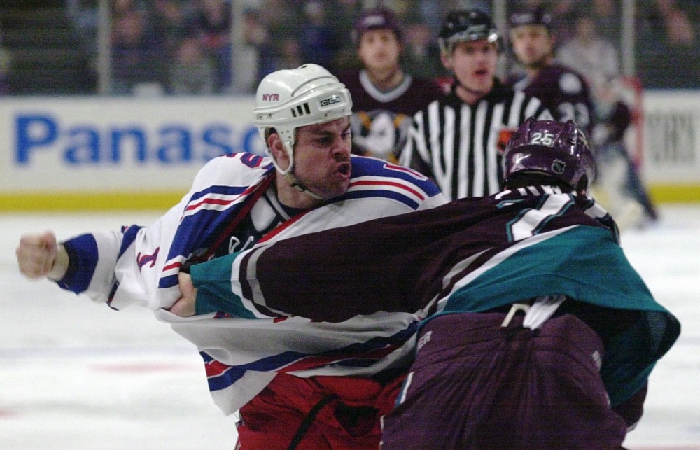 New York Rangers’ hockey player Dale Purinton, left, and Anaheim Mighty Ducks’ Kevin Sawyer fighting during the first period of an NHL game at Madison Square Garden in New York. Nov. 25, 2001 CREDIT: Ron Frehm, AP