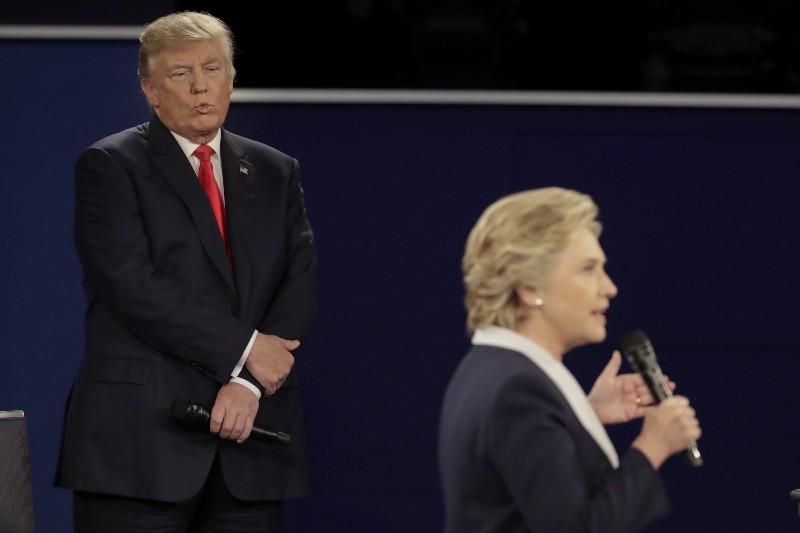 Republican presidential nominee Donald Trump listens as Democratic presidential nominee Hillary Clinton answers a question during the second presidential debate at Washington University in St. Louis, Sunday, Oct. 9, 2016. CREDIT: AP Photo/Julio Cortez