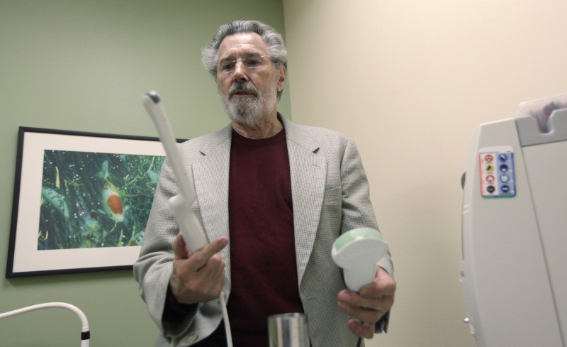 A doctor holding a transvaginal ultrasound probe in his hand. CREDIT: AP Photo/LM Otero