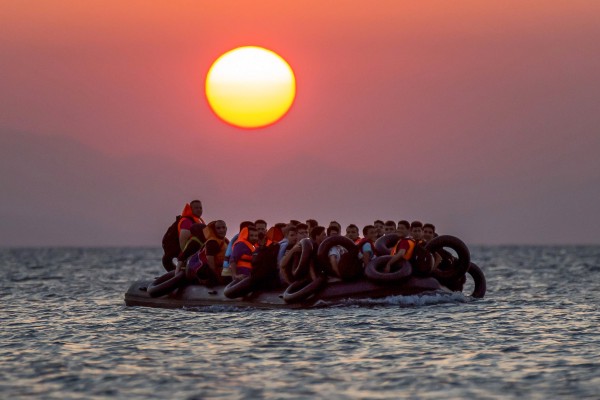 Migrants on a dinghy arrives at the southeastern island of Kos, Greece, after crossing from Turkey, Aug. 13, 2015. CREDIT: AP Photo/Alexander Zemlianichenko, File