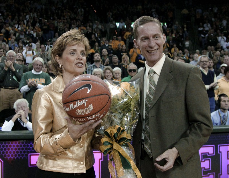 Baylor coach Kim Mulkey is given a basketball inscribed in honor of her 300th career victory, reached last Sunday, by athletic director Ian McCaw before a college basketball game Thursday Nov. 17, 2011, in Waco, Texas. CREDIT: AP Photo/Tony Gutierrez