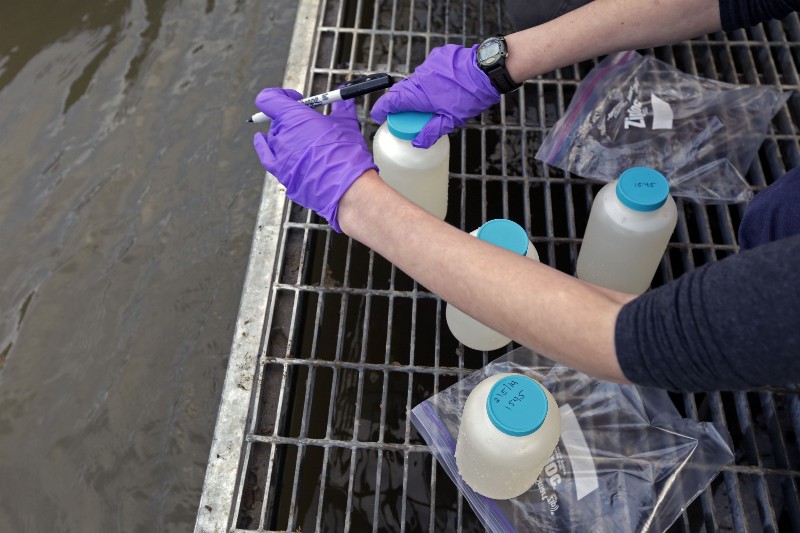 A contractor with the Environmental Protection Agency labels water samples from the Dan River as state and federal environmental officials continued their investigations of a spill of coal ash in Eden, N.C. in 2014. CREDIT: AP Photo/Gerry Broome