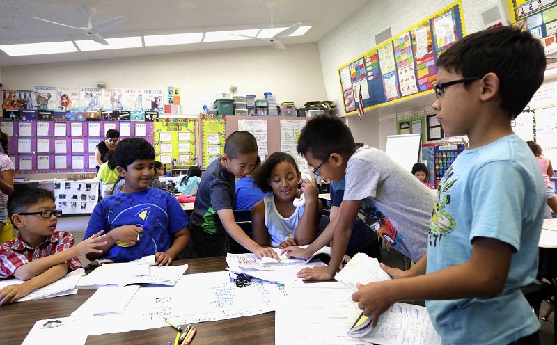 Second-graders wear light clothing under whirling ceiling fans, that provide little relief in a hot classroom without air conditioning, at Fryberger Elementary School in Westminster, Calif., Thursday, Oct. 20, 2016. CREDIT: AP/ Nick Ut