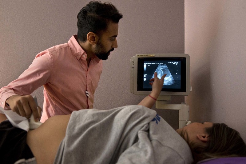Dr. Bhavik Kumar, 31, listens to a patient considering abortion during her ultrasound, in Fort Worth, Texas. Women considering abortion are required by the state to have a sonogram that they must be offered a chance to view. CREDIT: Jacquelyn Martin